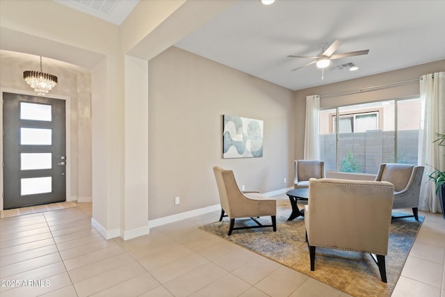 interior space featuring light tile patterned floors and ceiling fan with notable chandelier