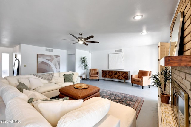 1106 N Villa Nueva Dr, Litchfield Park, AZ 85340 - living area with a fireplace, a ceiling fan, and finished concrete floors