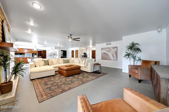 1106 N Villa Nueva Dr, Litchfield Park, AZ 85340 - living room featuring a ceiling fan, finished concrete floors, and recessed lighting