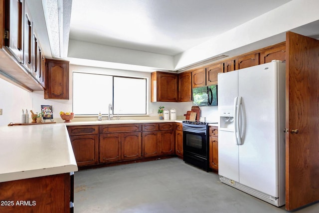 1106 N Villa Nueva Dr, Litchfield Park, AZ 85340 - kitchen featuring black appliances, finished concrete flooring, a sink, and brown cabinetry