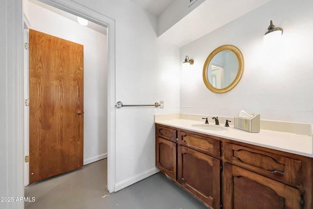 1106 N Villa Nueva Dr, Litchfield Park, AZ 85340 - bathroom with concrete floors, baseboards, and vanity