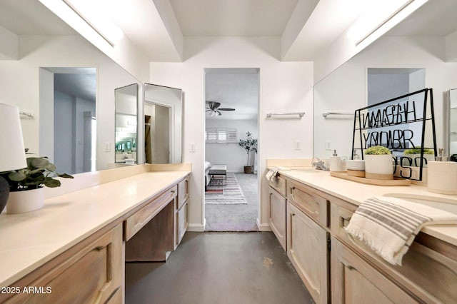 1106 N Villa Nueva Dr, Litchfield Park, AZ 85340 - ensuite bathroom featuring finished concrete flooring, vanity, a ceiling fan, and baseboards