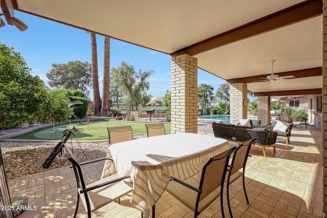 1106 N Villa Nueva Dr, Litchfield Park, AZ 85340 - view of patio with an area to practice putting, ceiling fan, an outdoor pool, and outdoor dining space
