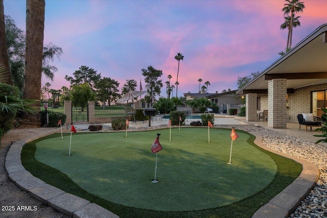 1106 N Villa Nueva Dr, Litchfield Park, AZ 85340 - view of property's community with a putting area, a patio, fence, and a swimming pool