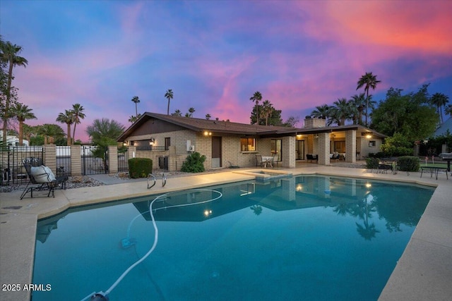1106 N Villa Nueva Dr, Litchfield Park, AZ 85340 - view of pool featuring a patio area, fence, and a pool with connected hot tub