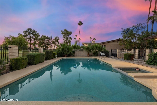 1106 N Villa Nueva Dr, Litchfield Park, AZ 85340 - pool at dusk featuring a fenced backyard