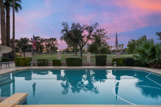 1106 N Villa Nueva Dr, Litchfield Park, AZ 85340 - pool at dusk featuring fence