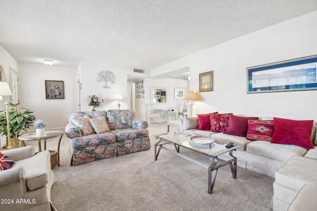 living room with carpet floors and a textured ceiling