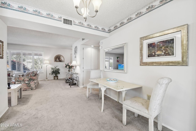 dining space with a textured ceiling and light carpet