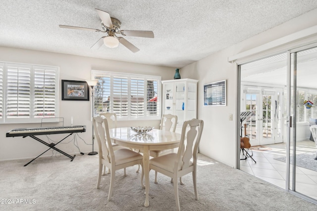 dining area featuring french doors, light colored carpet, a wealth of natural light, and ceiling fan