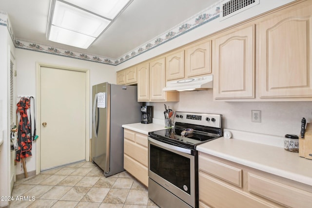 kitchen with appliances with stainless steel finishes, light brown cabinetry, and light tile patterned flooring