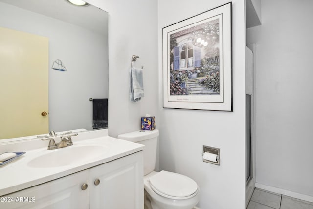 bathroom featuring tile patterned floors, vanity, and toilet