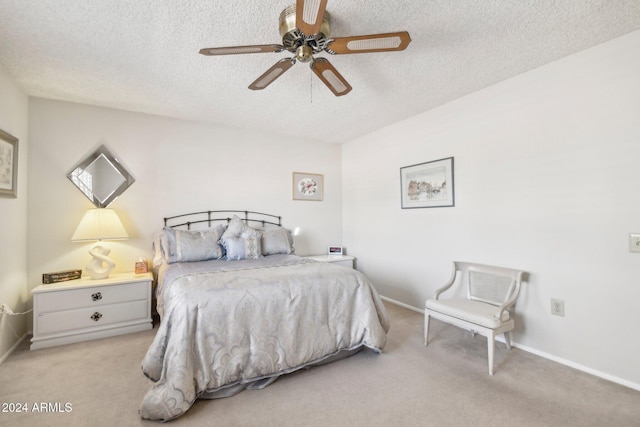 carpeted bedroom with a textured ceiling and ceiling fan