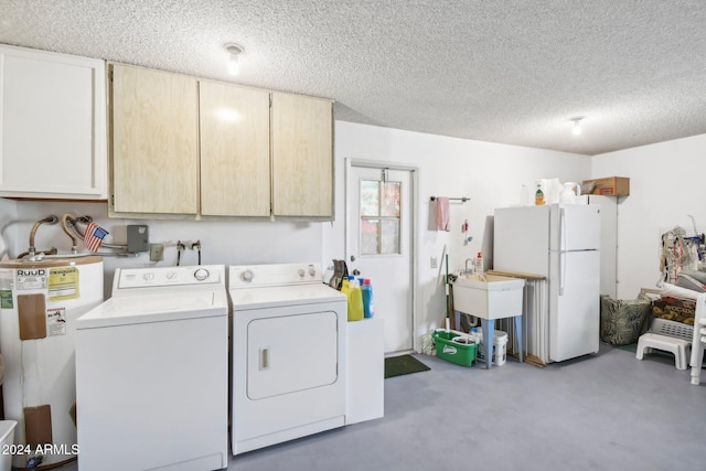 laundry room featuring separate washer and dryer, water heater, cabinets, and a textured ceiling