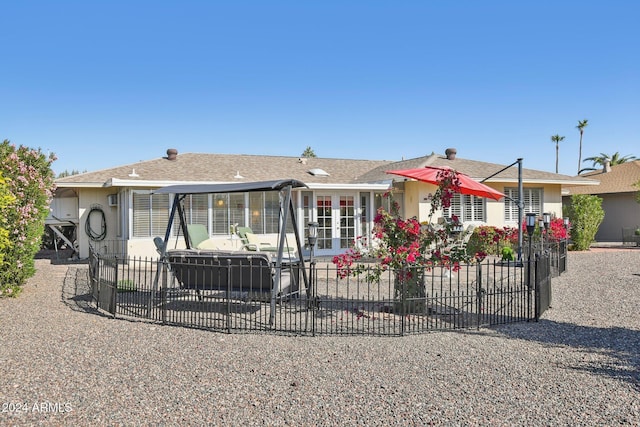 view of front of property with french doors and a patio