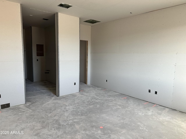 unfurnished bedroom with visible vents and unfinished concrete flooring