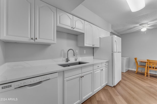 kitchen featuring white appliances, light hardwood / wood-style floors, white cabinetry, and sink