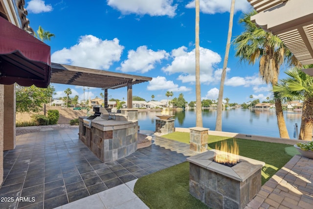 1241 W Lobster Trap Dr, Gilbert, AZ 85233 - view of patio / terrace with a fire pit, a water view, and an outdoor kitchen
