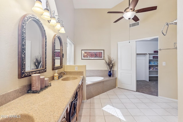 1241 W Lobster Trap Dr, Gilbert, AZ 85233 - bathroom with a towering ceiling, tile patterned floors, a garden tub, vanity, and a ceiling fan