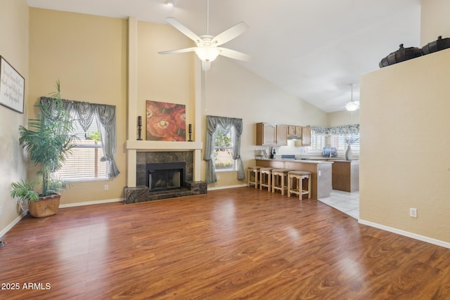 1241 W Lobster Trap Dr, Gilbert, AZ 85233 - living area with a ceiling fan, high vaulted ceiling, plenty of natural light, light wood finished floors, and a tiled fireplace