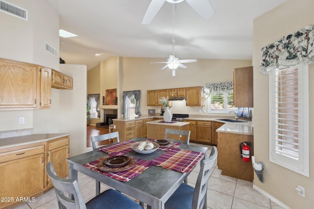 1241 W Lobster Trap Dr, Gilbert, AZ 85233 - dining room with a ceiling fan, light tile patterned flooring, high vaulted ceiling, and a fireplace