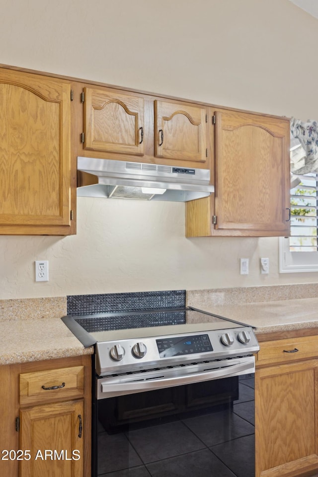 1241 W Lobster Trap Dr, Gilbert, AZ 85233 - kitchen featuring electric range, under cabinet range hood, tile patterned floors, and light countertops