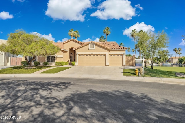 1241 W Lobster Trap Dr, Gilbert, AZ 85233 - mediterranean / spanish house with an attached garage, driveway, stucco siding, a tiled roof, and a water view