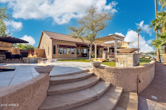1241 W Lobster Trap Dr, Gilbert, AZ 85233 - rear view of house with an outdoor fire pit, a tiled roof, stucco siding, and a patio area
