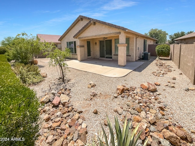 back of property with ceiling fan, cooling unit, and a patio area