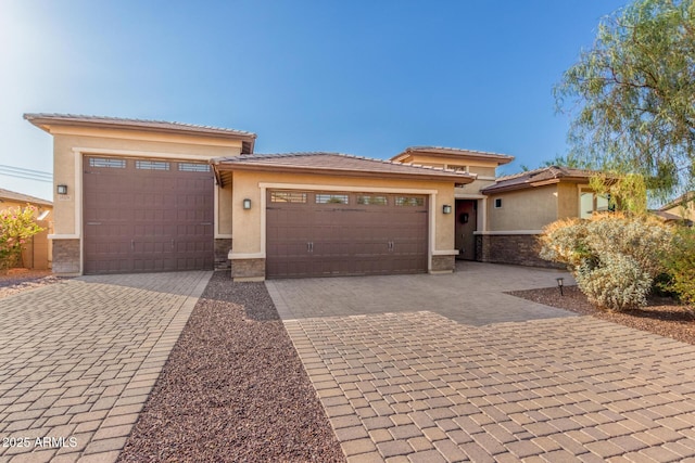 18108 W Cassia Way, Goodyear, AZ 85338 - prairie-style home with stucco siding, decorative driveway, and an attached garage