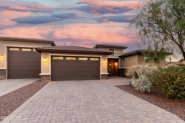 18108 W Cassia Way, Goodyear, AZ 85338 - prairie-style home featuring an attached garage, decorative driveway, and stucco siding