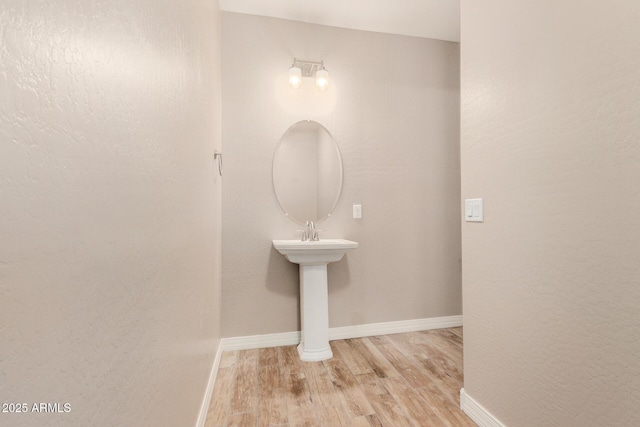 18108 W Cassia Way, Goodyear, AZ 85338 - bathroom featuring wood finished floors and baseboards