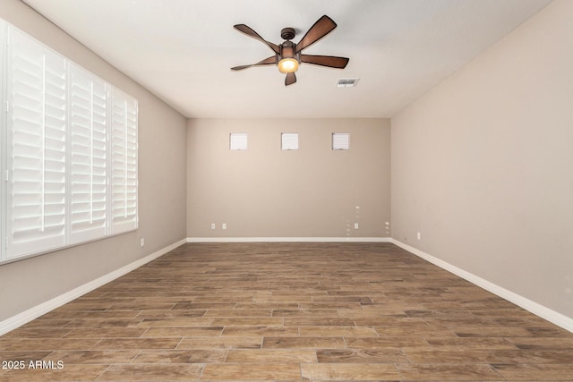 18108 W Cassia Way, Goodyear, AZ 85338 - unfurnished room featuring ceiling fan, healthy amount of natural light, and wood finished floors