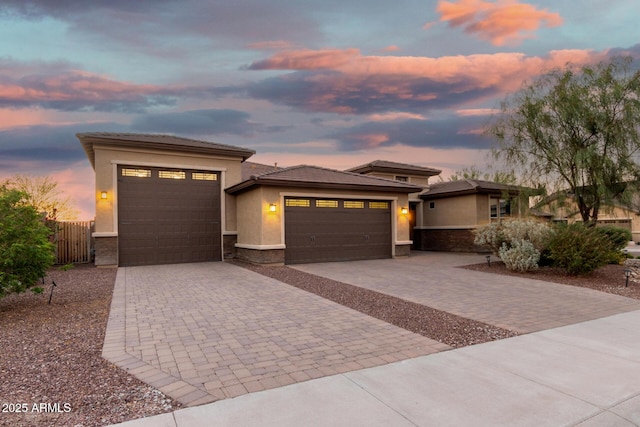 18108 W Cassia Way, Goodyear, AZ 85338 - prairie-style house featuring a garage, decorative driveway, stucco siding, and stone siding
