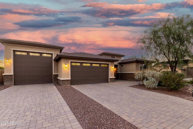 18108 W Cassia Way, Goodyear, AZ 85338 - prairie-style house featuring a garage, decorative driveway, stucco siding, and stone siding