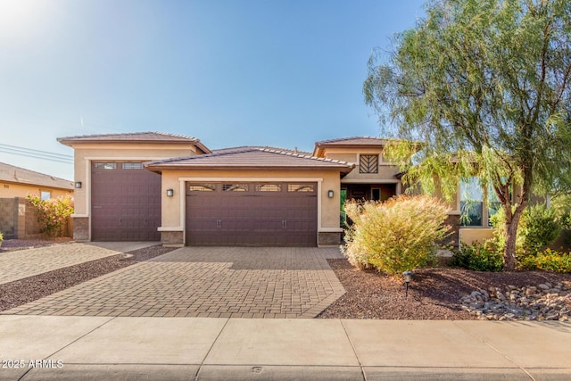 18108 W Cassia Way, Goodyear, AZ 85338 - prairie-style house with a garage, decorative driveway, stucco siding, and a tiled roof