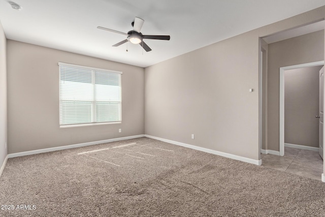 carpeted spare room with ceiling fan