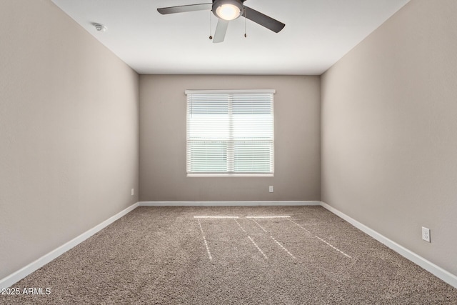 unfurnished room with ceiling fan and carpet