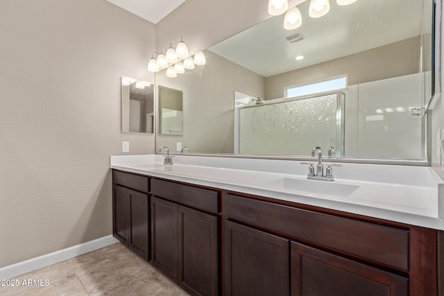 bathroom with tile patterned floors, vanity, and a shower with shower door