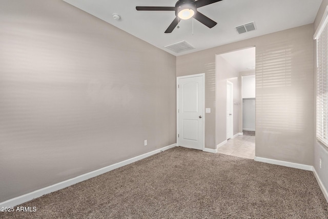 carpeted spare room featuring ceiling fan