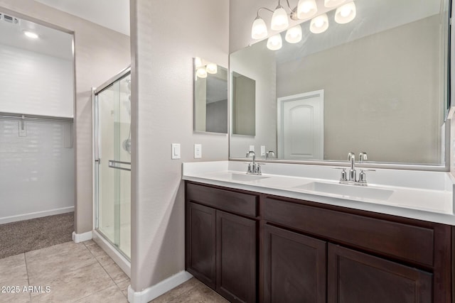 bathroom with tile patterned flooring, vanity, and an enclosed shower