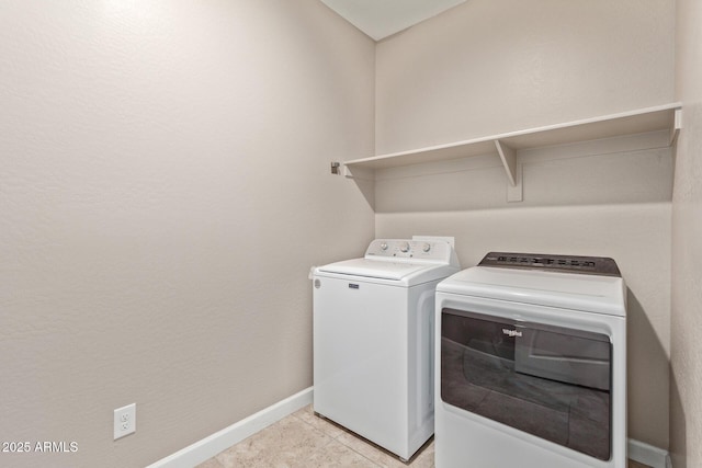 clothes washing area with separate washer and dryer and light tile patterned floors