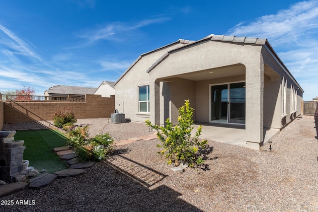 back of house featuring a patio area and central air condition unit