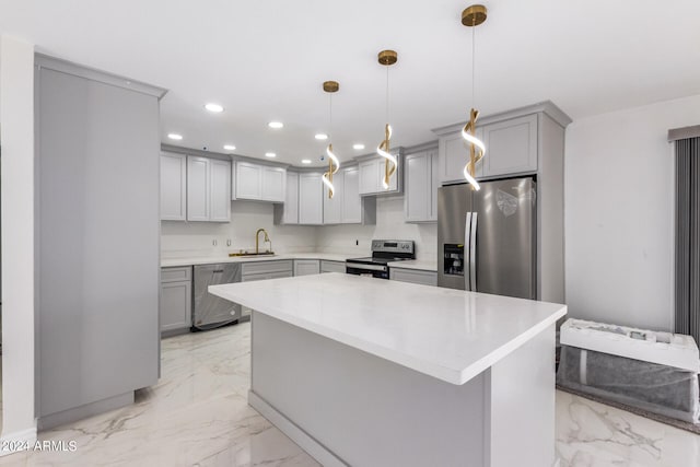 kitchen featuring pendant lighting, appliances with stainless steel finishes, gray cabinetry, light tile patterned floors, and sink