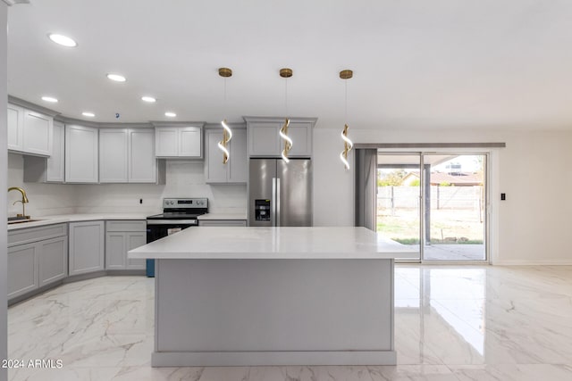 kitchen featuring gray cabinetry, light tile patterned flooring, stainless steel appliances, and decorative light fixtures