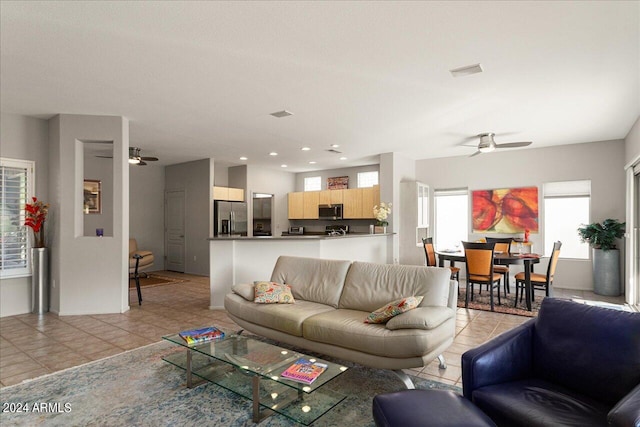 living room with ceiling fan and light tile patterned floors