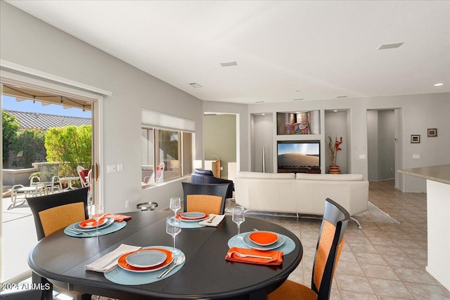 dining space featuring light tile patterned floors