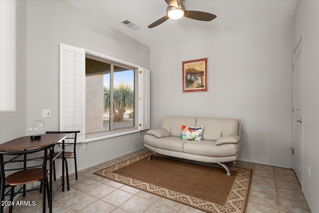 living room featuring ceiling fan and light tile patterned floors