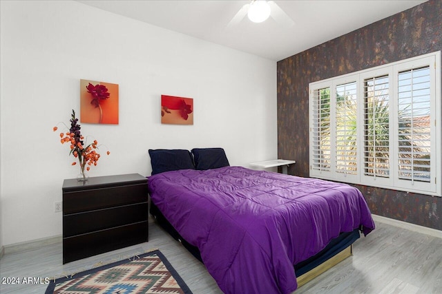 bedroom with light wood-type flooring and ceiling fan