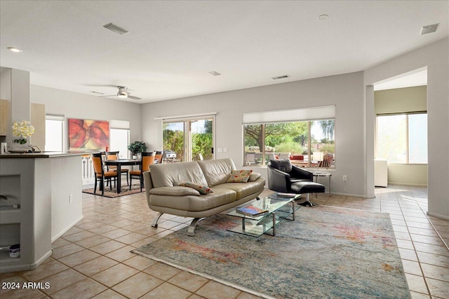 living room with light tile patterned floors and ceiling fan